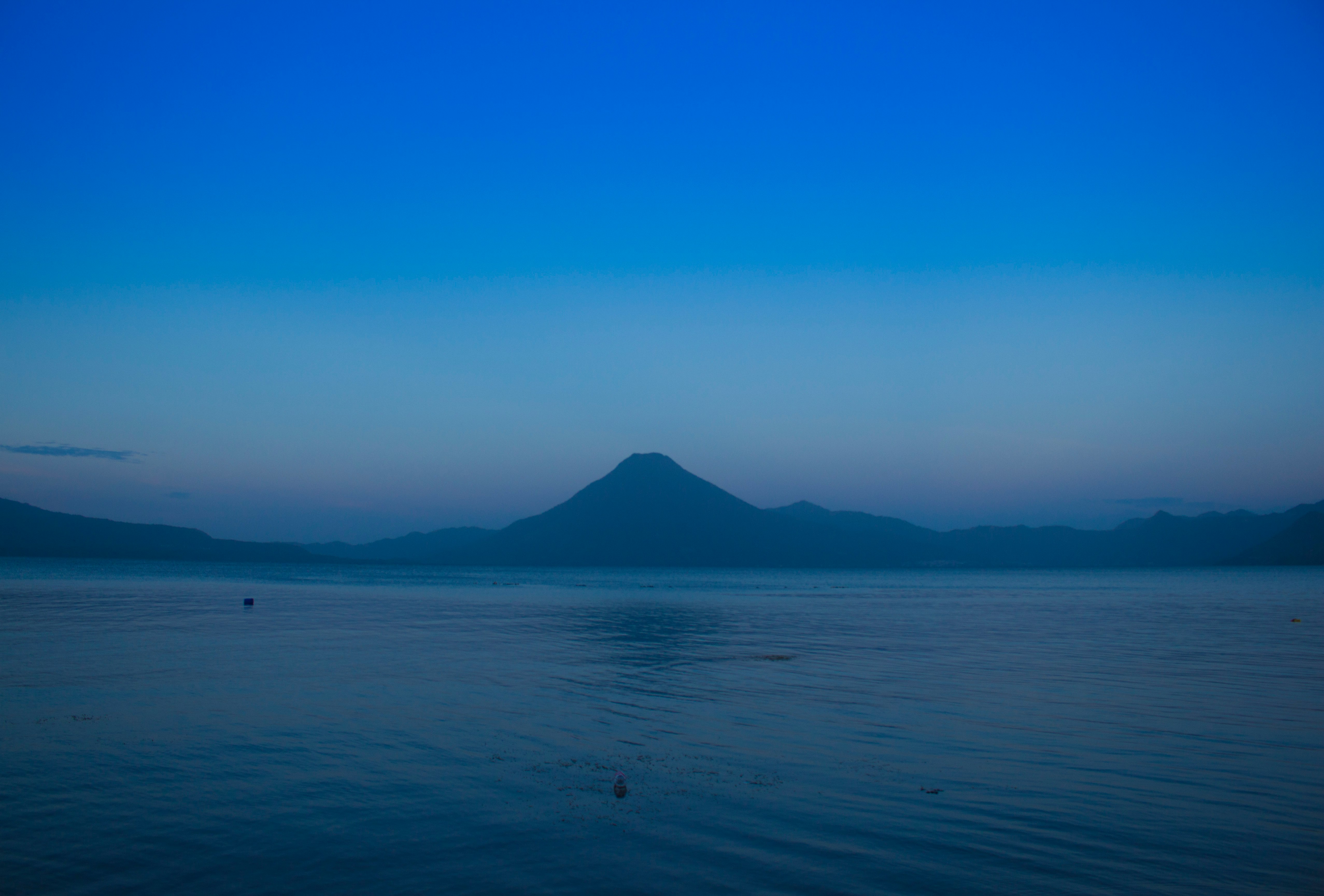 silhouette of mountains between sea and sky